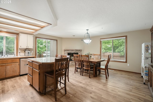12705 NE 101st St, Vancouver, WA 98682 - kitchen with stainless steel dishwasher, a sink, light countertops, a kitchen island, and light wood-style flooring