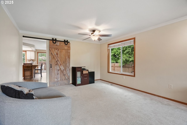 12705 NE 101st St, Vancouver, WA 98682 - living room featuring a barn door, crown molding, healthy amount of natural light, baseboards, and ceiling fan