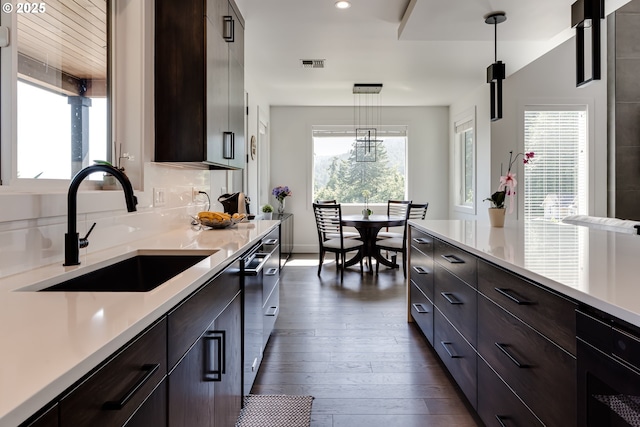 967 S 66th Pl, Springfield, OR 97478 - kitchen with plenty of natural light, light countertops, dark brown cabinetry, dark wood finished floors, and recessed lighting