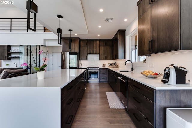 967 S 66th Pl, Springfield, OR 97478 - kitchen featuring stainless steel stove, dark brown cabinets, refrigerator, light countertops, and recessed lighting