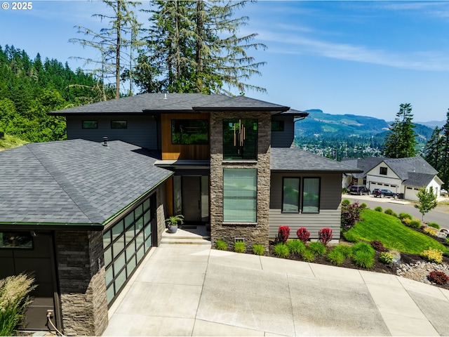 967 S 66th Pl, Springfield, OR 97478 - view of front of property featuring stone siding, a mountain view, roof with shingles, and a garage