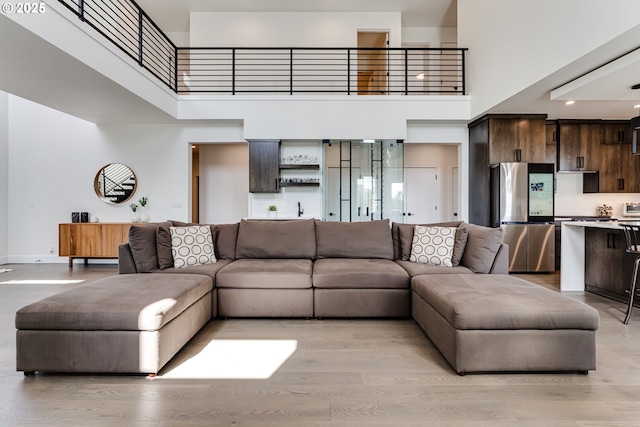 967 S 66th Pl, Springfield, OR 97478 - living area with a towering ceiling and light wood-style flooring