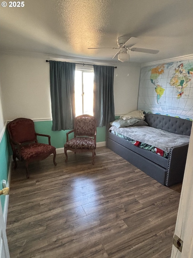 bedroom featuring dark hardwood / wood-style flooring, ornamental molding, a textured ceiling, and ceiling fan