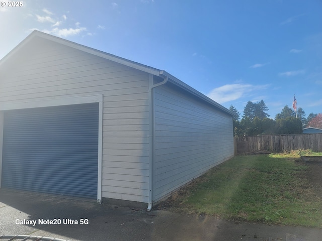 view of home's exterior featuring a garage and a lawn