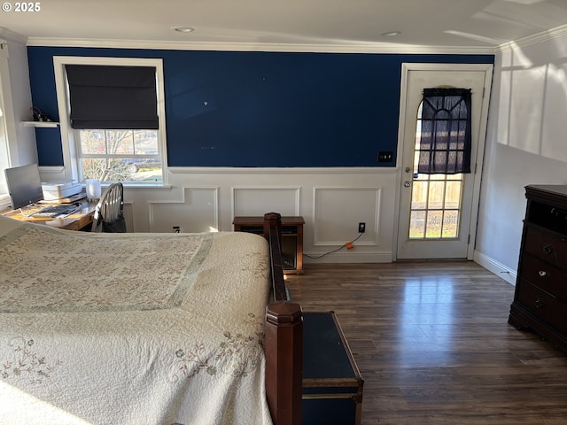 bedroom with multiple windows, ornamental molding, and dark wood-type flooring