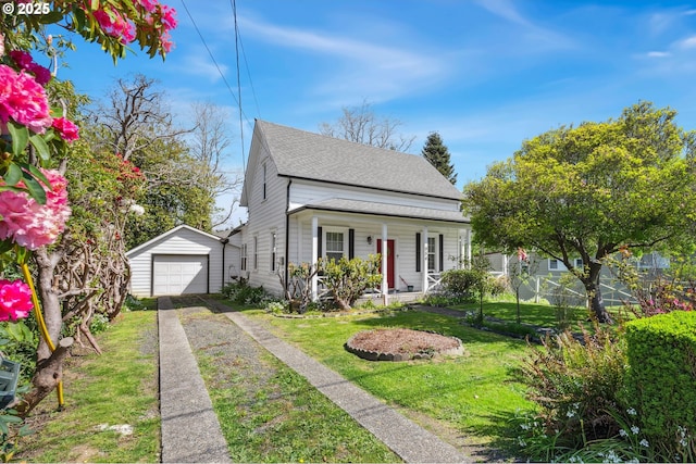 bungalow-style house featuring a porch, driveway, an outbuilding, a garage, and a shingled roof