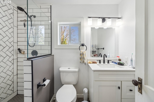 bathroom with vanity, a walk in shower, and toilet