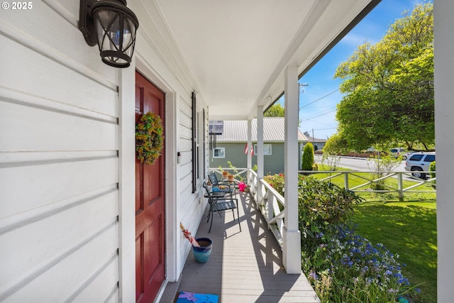 exterior space with a porch and a lawn