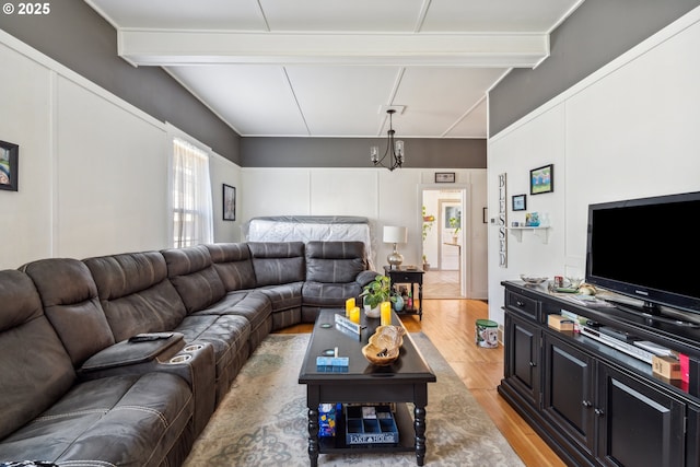living room featuring light wood-type flooring and beamed ceiling