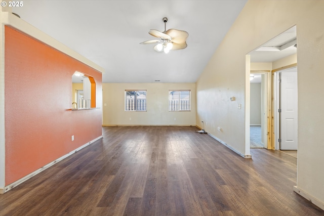 unfurnished living room with lofted ceiling, dark wood-type flooring, and ceiling fan