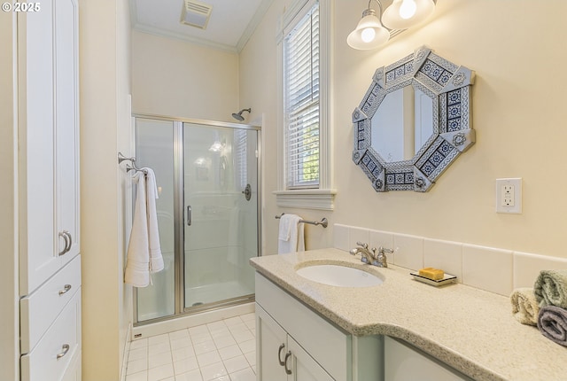 full bath with tile patterned floors, a shower stall, ornamental molding, and healthy amount of natural light