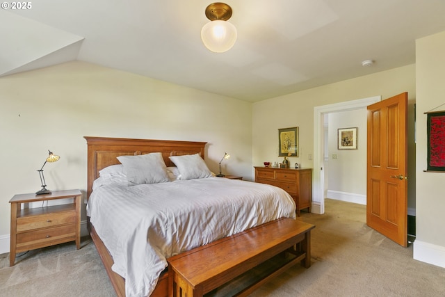 bedroom with light carpet and baseboards