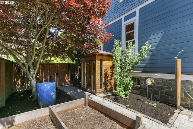 view of property exterior featuring a fenced backyard and mansard roof