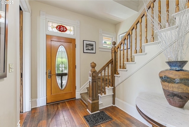 entrance foyer with wood-type flooring, stairs, and baseboards
