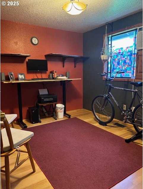 610 SE Maple St, Oakland, OR 97462 - workout area with a textured ceiling and wood finished floors
