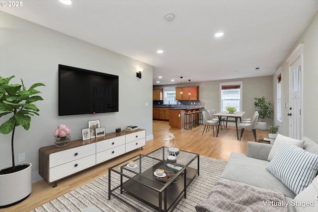 living area featuring recessed lighting and light wood-style floors