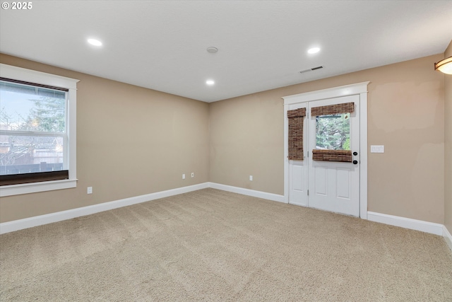 carpeted empty room with recessed lighting, visible vents, and baseboards