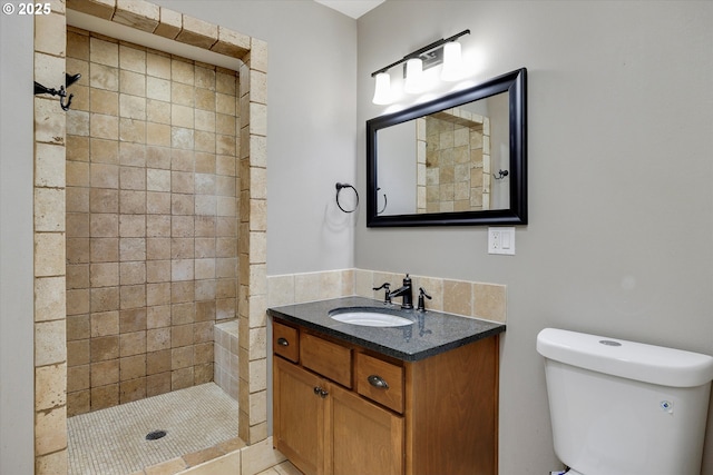 full bathroom with toilet, a stall shower, and vanity