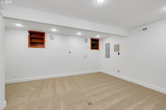 finished basement featuring visible vents, electric panel, recessed lighting, carpet floors, and baseboards