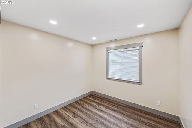 unfurnished room featuring dark wood-type flooring