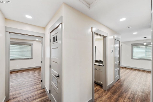 corridor with dark hardwood / wood-style floors