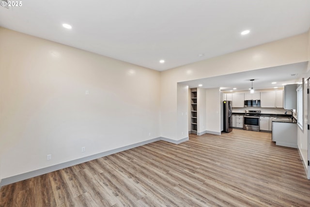 unfurnished living room with light wood-type flooring