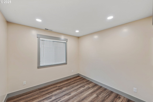 spare room with dark hardwood / wood-style floors