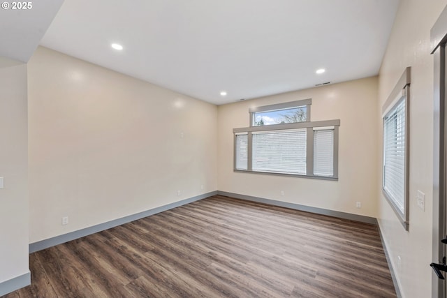 spare room with dark hardwood / wood-style flooring