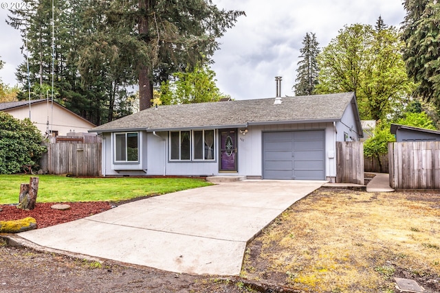 ranch-style house with fence, roof with shingles, a front lawn, a garage, and driveway