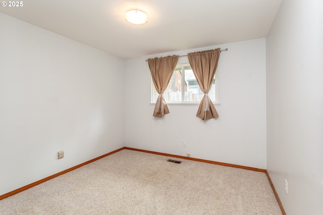 unfurnished room featuring baseboards, carpet flooring, and visible vents