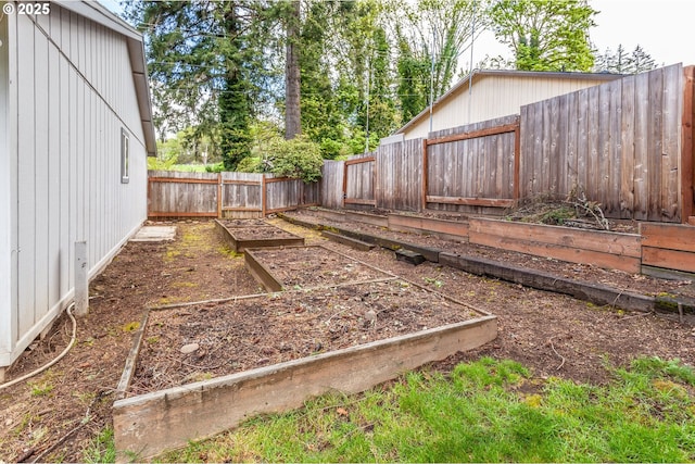 view of yard featuring a fenced backyard and a vegetable garden