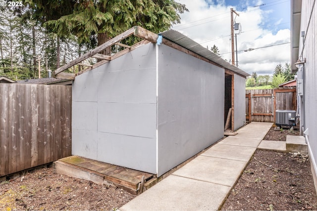 view of shed featuring central air condition unit and a fenced backyard