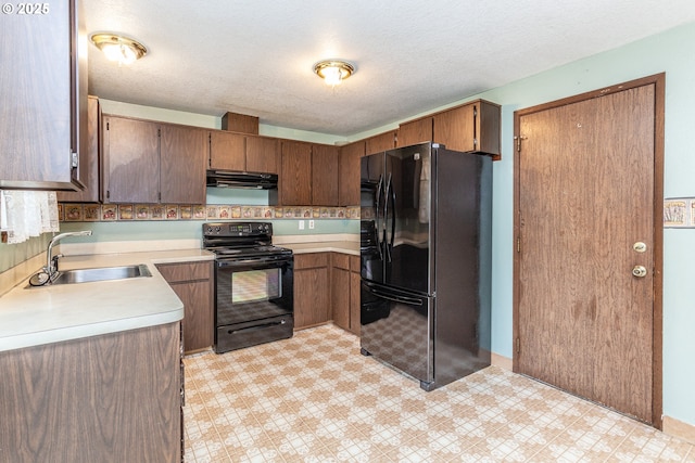 kitchen with exhaust hood, a sink, light countertops, light floors, and black appliances