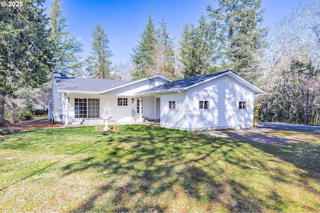 ranch-style home with a front lawn