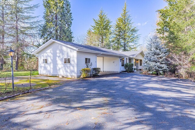 view of side of property with aphalt driveway