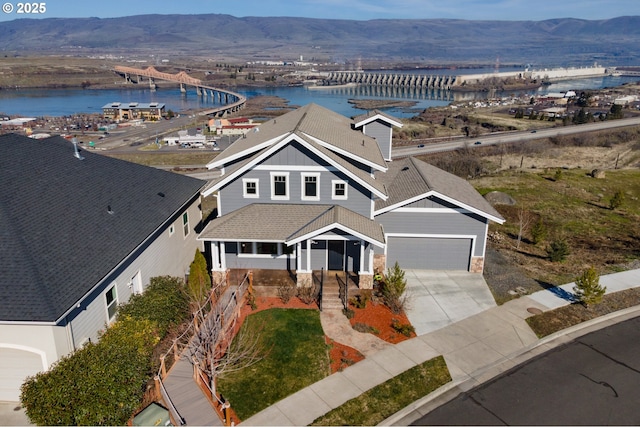 birds eye view of property with a water and mountain view