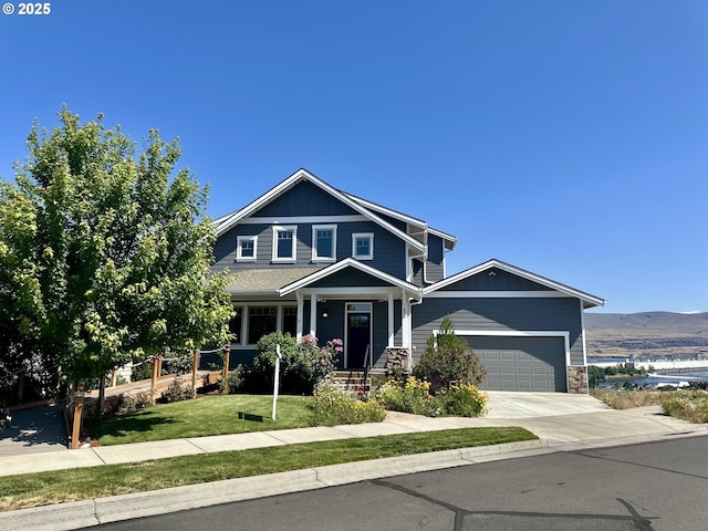 371 Summit Ridge Dr, The Dalles, OR 97058 - view of front of property with a garage, driveway, a front yard, stone siding, and a mountain view