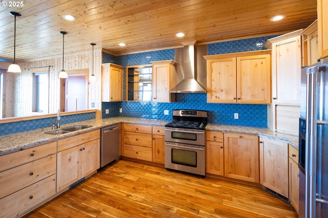 kitchen with stainless steel appliances, wood ceiling, light brown cabinets, a sink, and wall chimney range hood