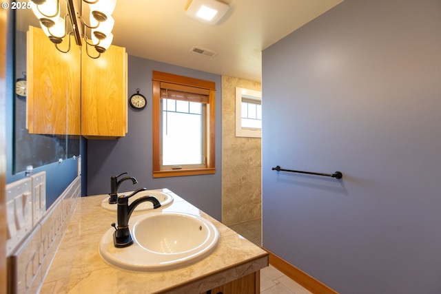 371 Summit Ridge Dr, The Dalles, OR 97058 - bathroom featuring a chandelier, double vanity, and baseboards