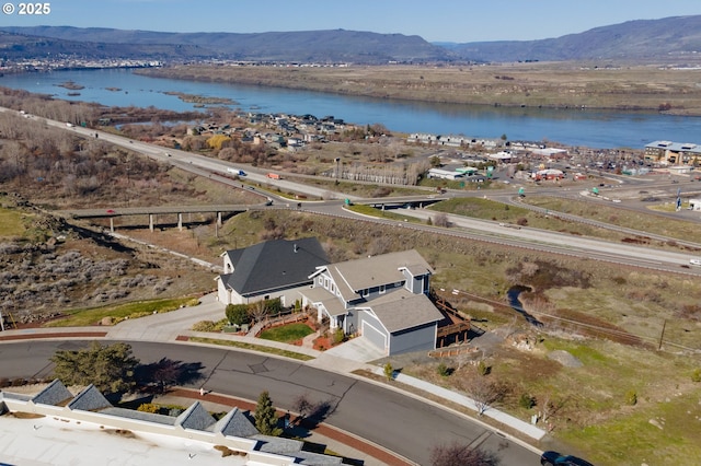 bird's eye view with a water and mountain view