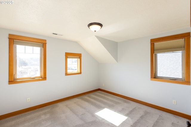 bonus room featuring vaulted ceiling, carpet, visible vents, and baseboards