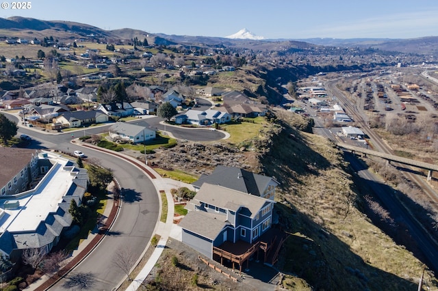 drone / aerial view featuring a residential view and a mountain view