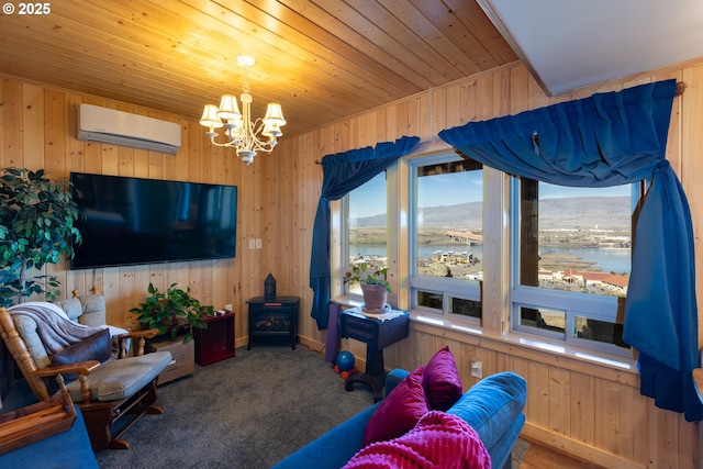 living room featuring an inviting chandelier, an AC wall unit, carpet flooring, wood walls, and wooden ceiling