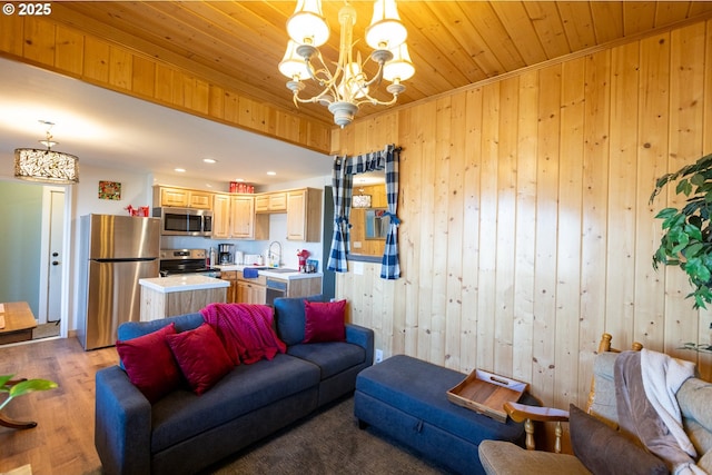 living room with light wood-type flooring, wood ceiling, wooden walls, and a chandelier