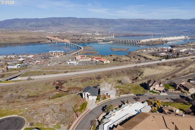 birds eye view of property with a water and mountain view