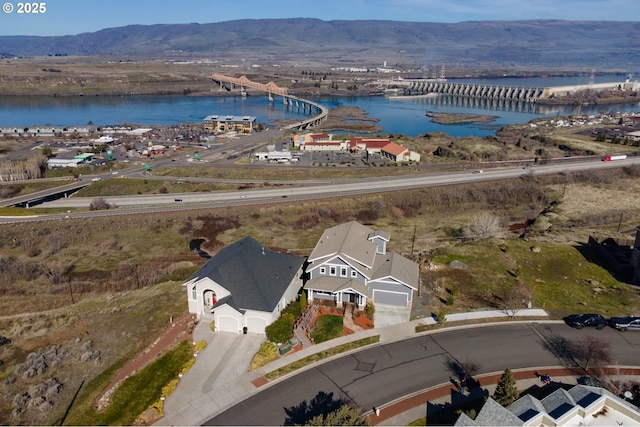 birds eye view of property with a water and mountain view