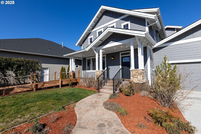 craftsman inspired home with covered porch, a front lawn, and board and batten siding