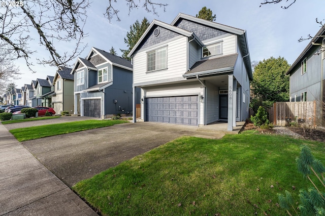 view of front of property featuring a garage and a front lawn