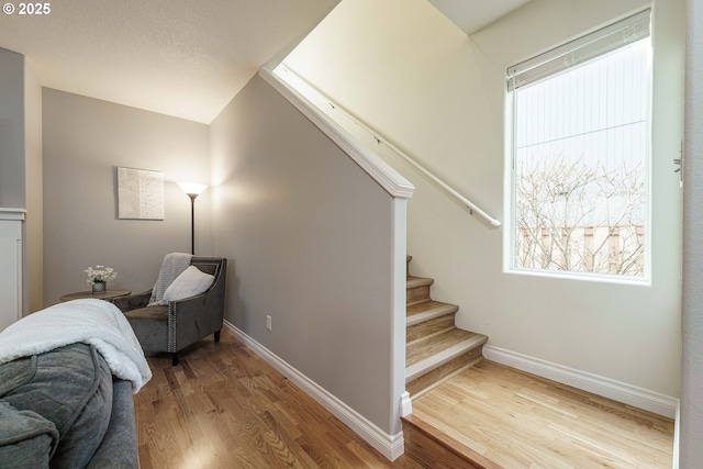 stairs featuring hardwood / wood-style floors