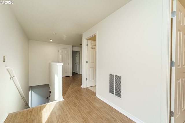 corridor with light hardwood / wood-style flooring